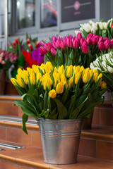 Many different colors on the stand table in the flower shop. Showcase. Background of mix of flowers. Beautiful flowers for catalog or online store. Floral shop and delivery concept.