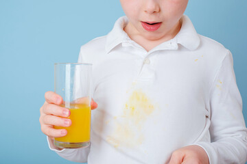 Dirty stain of orange juice on clothes. The concept of cleaning stains on clothes