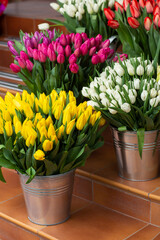 Many different colors on the stand table in the flower shop. Showcase. Background of mix of flowers. Beautiful flowers for catalog or online store. Floral shop and delivery concept.