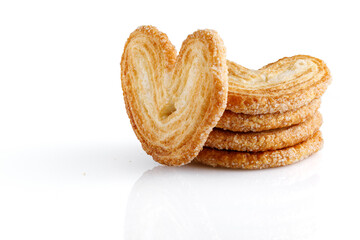 Palmier cookies or puff pastry ears isolated on white background. Cookies in the shape of a heart....