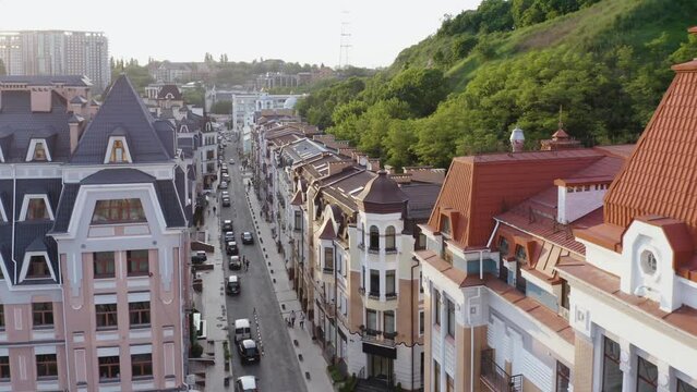European buildings with car traffic on the thin street. Aerial drone view pof summer cityscape.
