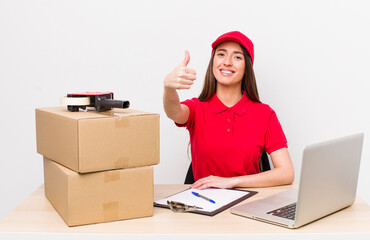 hispanic pretty woman feeling proud,smiling positively with thumbs up. company employee concept