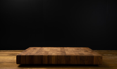 Wooden board for cutting on a black background. - Powered by Adobe