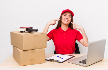 hispanic pretty woman smiling confidently pointing to own broad smile. company employee concept