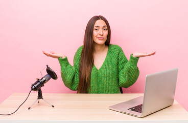 hispanic pretty woman feeling puzzled and confused and doubting. influencer concept