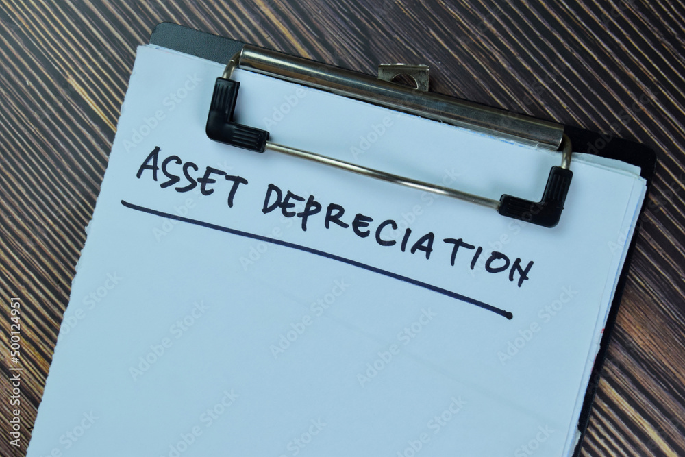 Wall mural Asset Depreciation write on a paperwork isolated on Wooden Table.