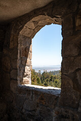 Side view of a forest and mountains from the window of an old Bismarck tower in Chile.