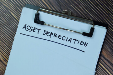 Asset Depreciation write on a paperwork isolated on Wooden Table.