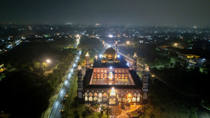Fototapeta na wymiar The Largest Mosque Masjid Kubah Emas at Depok at night, Ramadan Eid Concept background, Travel and tourism. Depok, Indonesia April 21 2022