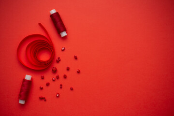 Red threads, red beads and red ribbon