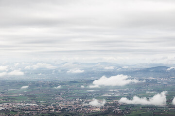 View from above of Umbria valley, with cloudscape both above and below