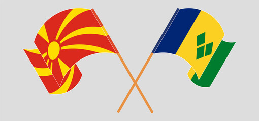 Crossed and waving flags of North Macedonia and Saint Vincent and the Grenadines
