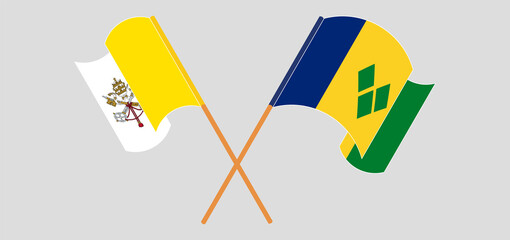 Crossed and waving flags of Vatican and Saint Vincent and the Grenadines
