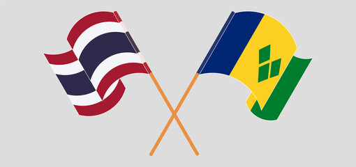 Crossed and waving flags of Thailand and Saint Vincent and the Grenadines