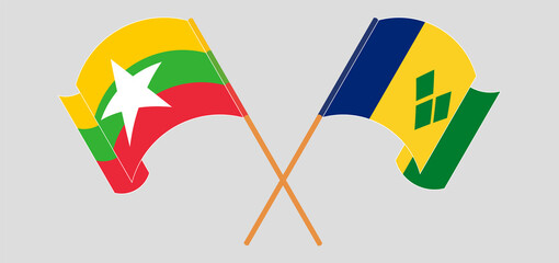 Crossed and waving flags of Myanmar and Saint Vincent and the Grenadines