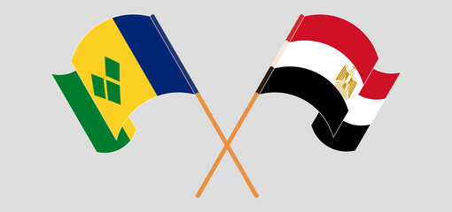 Crossed and waving flags of Saint Vincent and the Grenadines and Egypt