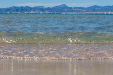 Beach, Mediterranean sea and waves at the of Arenal, Majorca, Spain