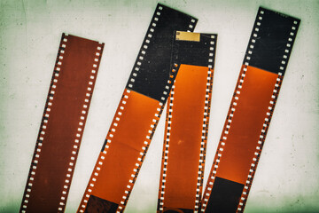 Set of 35mm negative film strip, vintage background with intentional grain, noise, dust, scratches