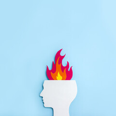 Cardboard application of the silhouette of human head and  flame. Minimal concept of professional and emotional burnout. Square orientation, copy space