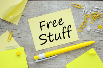 Free Stuff text on yellow sticky note on wooden background