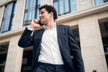 A male business manager in a formal suit goes to work in the office