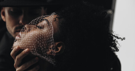 Creative photo. Man and young african american woman with curly hair with mesh on face. smelling...