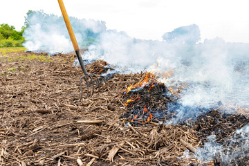 Cornfield fire with corn stover and trash burning in farm field. Farming, agriculture and flooding...