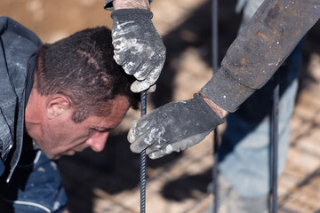 Construction workers fabricating steel reinforcement bar at the construction site