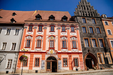 Fototapeta premium Cheb, Western Bohemia, Czech Republic, 14 August 2021: King George of Podebrady Square, Eger at sunny summer day, medieval colorful gothic merchant, historic renaissance and baroque buildings