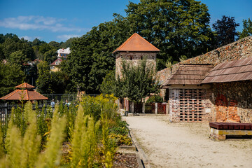 Cheb, Western Bohemia, Czech Republic, 14 August 2021: Gothic stone castle, medieval historic fortress or stronghold in sunny summer day, black Tower, ballista wooden siege weapons near defense walls
