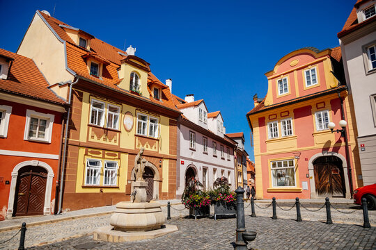 Cheb, Western Bohemia, Czech Republic, 14 August 2021: picturesque street with medieval colorful gothic houses, Fountain of St. Nicholas at Ruzovy kopecek at sunny summer day, baroque buildings