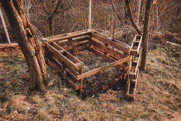 open euro pallet composter in garden with garden and kitchen leftovers inside, Permaculture composting concept