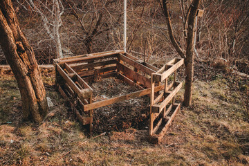 open euro pallet composter in garden with garden and kitchen leftovers inside, Permaculture composting concept