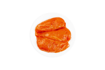 Marinated chicken fillet in red sauce on an isolated background.Fast food, food at home.Top view. Copy space.