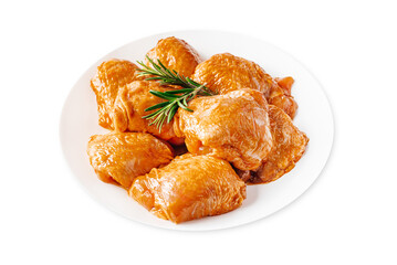 Marinated chicken thighs in red sauce on isolated white background.Copy space.Semifinished. Fast cooking.Raw marinated chicken meat.Top view.