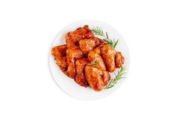 Marinated chicken wings in red sauce on isolated white background.Copy space.Semifinished. Fast cooking.Raw marinated chicken meat.Top view.