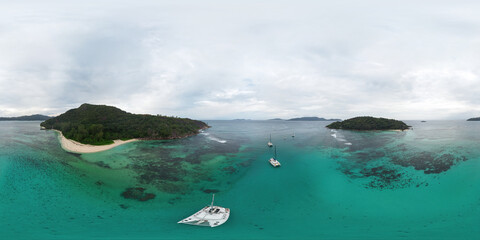 HDRI seamless spherical aerial 360-degree panorama of Praslin island, Seychelles. View of the luxurious wild Anse Cocos beach with tourist sailing catamarans anchored near it © Sergey Chips