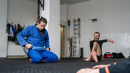 Fototapeta na wymiar Brazilian jiu jitsu class at the academy male athletes preparing for training BJJ jiujitsu concept