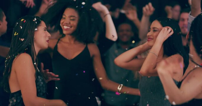 The night may not last forever but the memories will. 4k video footage of young women dancing together at a party surrounded by falling confetti.