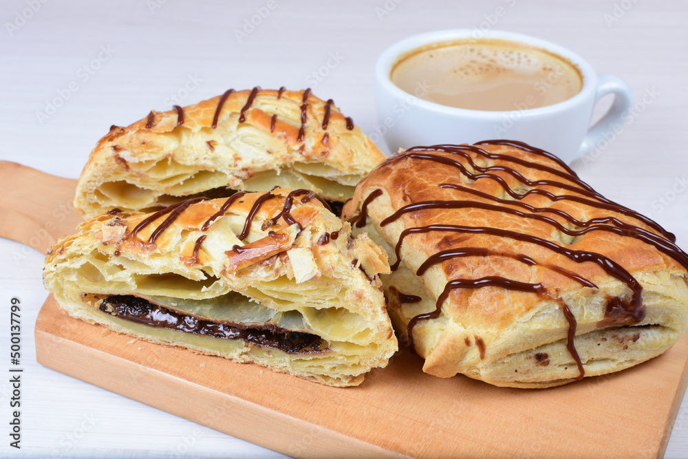 Sticker Puff pastry chocolate cake, accompanied by chocolate sauce on wooden background