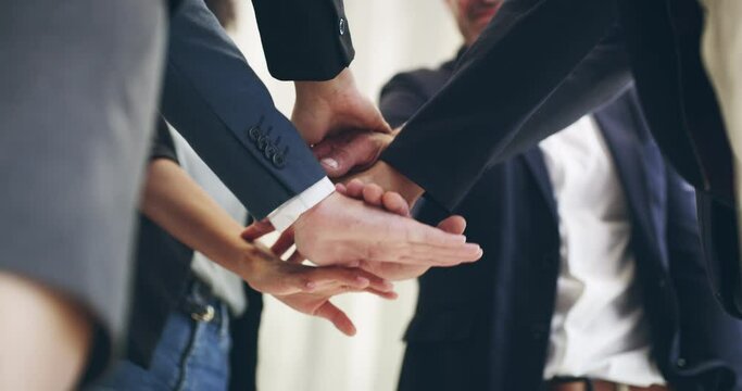 Go team. 4k video footage of a group of businesspeople standing with their hands in a huddle.