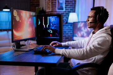 Cheerful person live streaming shooter video games on computer, broadcasting multiplayer action...