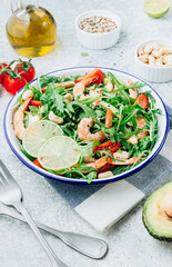Shrimps salad with tomato, arugula, avocado and cashew nuts