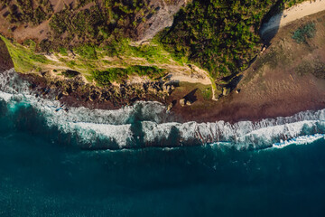 Cliff with rocks and ocean with waves at Bali. Aerial view in Uluwatu