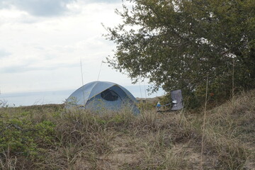 Light Green Igloo Tent in Sandy Dune with Camp Chair in Daylight