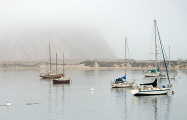 Fototapeta na wymiar Early morning fog over Morro Bay harbor on the Central Coast of California United States