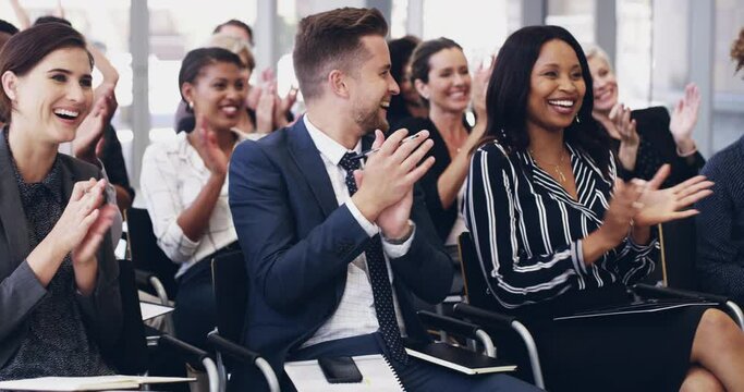 Acknowledge success and it will acknowledge you. 4k footage of a group of businesspeople clapping hands while sitting in a conference.