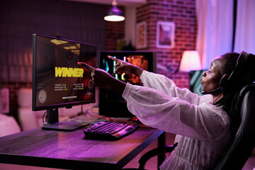 African american gamer streaming online video games play on pc, playing action game championship in...