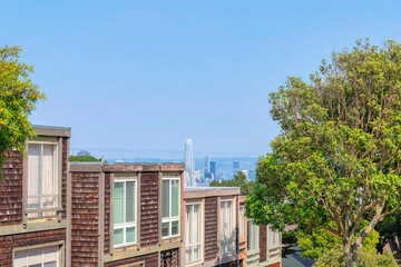 View of flat roofs of townhouses with wooden shingle sidings in San Francisco, California