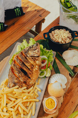 Beach Colorful Food Appetizer Starts Snacks Fresh Delicious Menu Recipe Meal Meat Chicken Fries Fish Seafood Beer on a wooden table